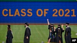 University of Pittsburgh candidates for graduation line up to receive their diplomas during a ceremony in Pittsburgh, Tuesday, May 4, 2021. (AP Photo/Gene J. Puskar)