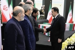 Iraqi Prime Minister Mohammed Shia al-Sudani, right, offers his condolences to Iran's caretaker president, Mohammad Mokhber, and other officials in Tehran on May 22, 2024. (Iraqi Prime Minister's Press Office via AFP)