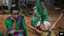 FILE - Relatives of Samual Moro, 30, grieve after he died of cholera, outside the cholera isolation ward at the Juba Teaching Hospital in the capital Juba, South Sudan.