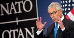 FILE - Then-U.S. Secretary of Defense Chuck Hagel speaks during a media conference at NATO headquarters in Brussels, Feb. 5, 2015.