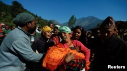 A woman holding a child who died during an earthquake mourns in Jajarkot, Nepal November 5, 2023.
