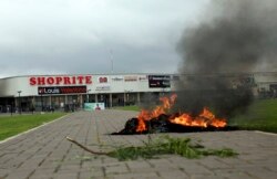 FILA bonfire is set outside Shoprite during a protest in Abuja, Nigeria, Sept. 4, 2019. S. African-owned businesses operating in Nigeria are being targeted in retaliation for xenophobic attacks carried out against Africans working in South Africa.