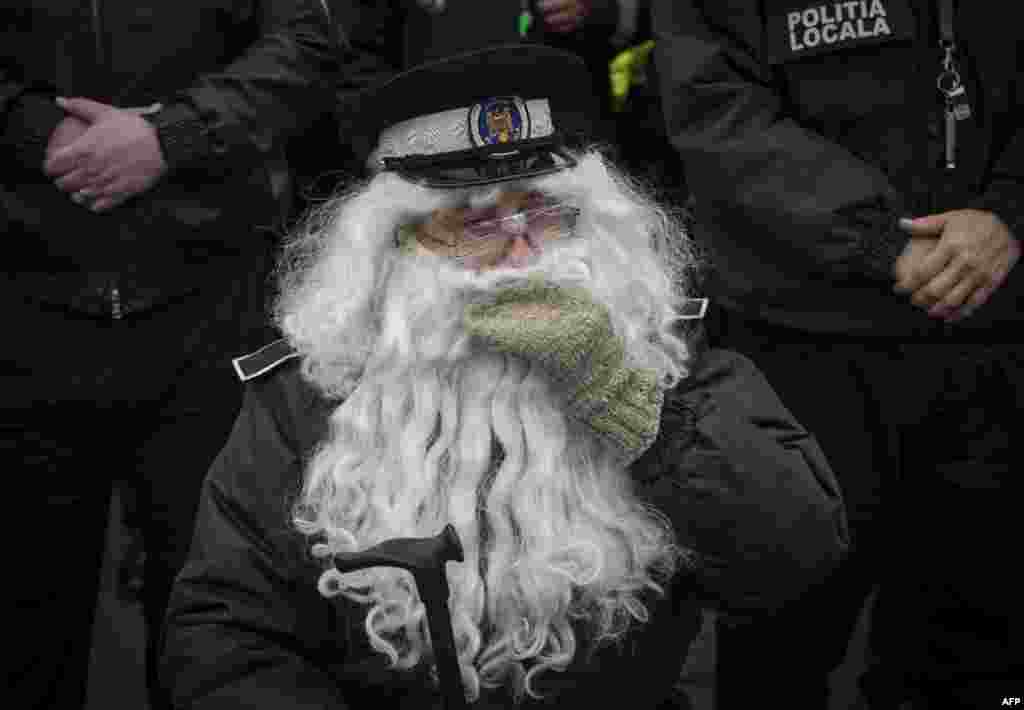 A Romanian local police officer wears a fake beard to impersonate an elderly employee during a protest in Bucharest.