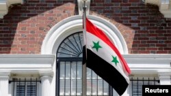 FILE - A flag flies at the Syrian Embassy in Washington.