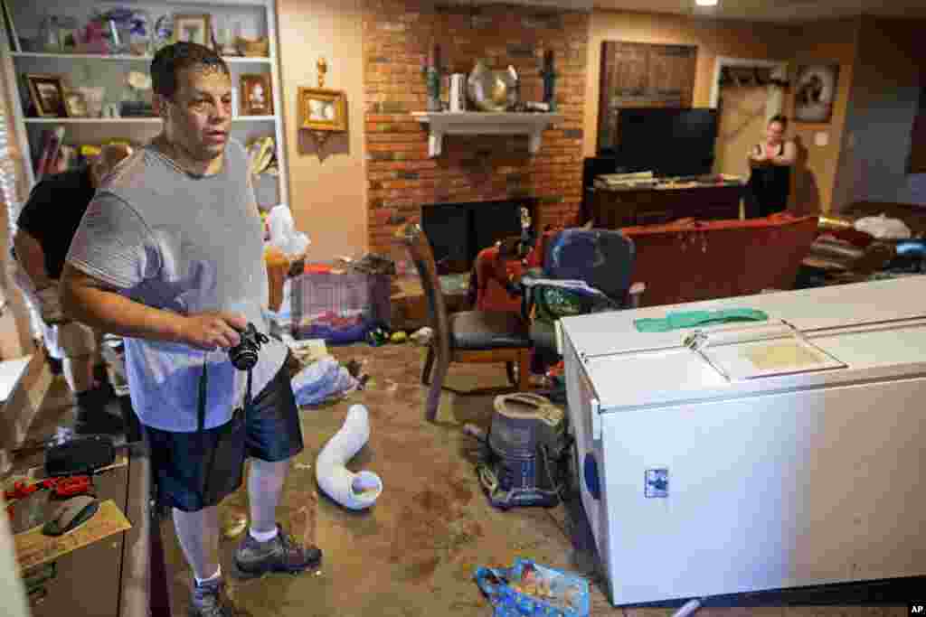 Raymond Lieteau takes photos his flood-damaged home in Baton Rouge, Louisiana, Aug. 16, 2016. Lieteau had more than five feet of water in his home. 