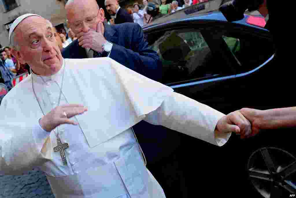 Pope Francis is greeted by a faithful as he arrives at the Chiesa Del Gesu&#39; in Rome, Italy. 