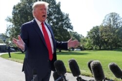 U.S. President Donald Trump talks to reporters as he departs for travel to New York and New Jersey from the South Lawn of the White House in Washington, Aug. 9, 2019.