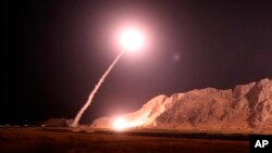 FILE - In this photo released on Oct. 1, 2018, by the Iranian Revolutionary Guard, a missile is fired from city of Kermanshah in western Iran targeting the Islamic State group in Syria.