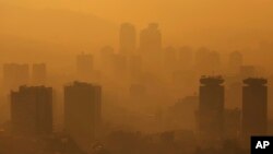 FILE - General view of the city during a sunset as smog covers Sarajevo, Bosnia, Nov. 14, 2022. 