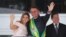 Presiden Brazil, Jair Bolsonaro didampingi ibu negara, Michelle Bolsonaro, di Istana Planalto usai pelantikan di Brasilia, Brazil, 1 Januari 2019.