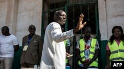 Guinea Bissau's president Jose Mario Vaz waves as he gets ready to cast his vote at a polling station in Bissau, on November 24, 2019.
