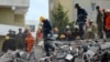 Emergency personnel work at the site of a collapsed building in the town of Durres, following Tuesday's powerful earthquake that shook Albania, Nov. 27, 2019.