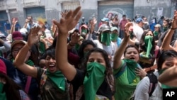 Youths shout slogans against the government of President Jimmy Morales, in Guatemala City, Sept. 11, 2018. Morales had announced that he would not renew the U.N.-backed commission investigating corruption in the country for another two-year mandate, giving the commission until the end of its current term in September 2019 to transfer all its functions to Guatemalan institutions. 