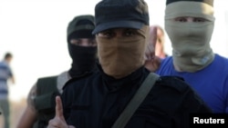 Islamist rebels from Hayat Tahrir al-Sham are seen outside the villages of al-Foua and Kefraya, Syria, July 18, 2018. 