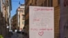 A hand written notice on the window of a shop advises that the shop will remain close for public health reason, concluding "All will be fine", in downtown Rome, March 12, 2020. 
