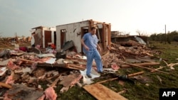  Nathan Ulepich searches outside the back of his house destroyed after a powerful tornado ripped through the area on May 20, 2013 in Moore, Oklahoma. 
