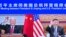 In this photo released by Xinhua News Agency, Chinese President Xi Jinping, right, and U.S. President Joe Biden appear on a screen as they hold a meeting via video link, in Beijing, China, Nov. 16, 2021. 