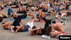 FILE - People gather for physical exercise in Nantes, France, Sept. 18, 2017. 