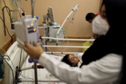 A wounded Palestinian girl lies on a bed in Shifa hospital in Gaza City, May 17, 2021.