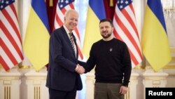 Ukraine's President Volodymyr Zelenskyy and U.S. President Joe Biden shake hands before a meeting, amid Russia's attack on Ukraine, in Kyiv, Ukraine Feb. 20, 2023. 