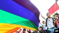 FILE - Participants revel through a street during a gay and lesbian parade in Taipei, Taiwan.