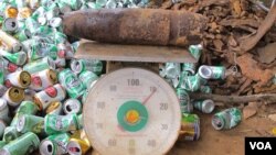 Bomb on scales at scrap yard. (VOA/M. Brown) 