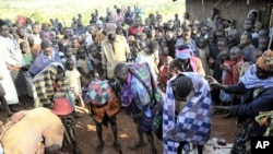 People gather around teenage girls from Uganda's Sebei tribe who have just undergone female genital mutilation near Kampala, Feb. 2011 (file photo).