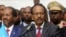 Somalia's newly elected President Mohamed Abdullahi Farmajo flanked by outgoing president Hassan Sheikh Mohamud (L) addresses lawmakers after winning the vote at the airport in Somalia's capital Mogadishu, Feb. 8, 2017.