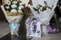 A makeshift memorial for Li Wenliang, a doctor who issued an early warning about the coronavirus outbreak before it was officially recognized, is seen after Li died of the virus, at Central Hospital of Wuhan in Hubei province, China, Feb. 7, 2020.