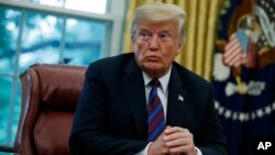 President Donald Trump talks on the phone with Mexican President Enrique Pena Nieto, in the Oval Office of the White House, Aug. 27, 2018, in Washington.