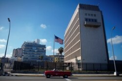 Tourists in a vintage car pass by the U.S. Embassy in Havana, Cuba, Nov. 7, 2019.