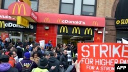 A coalition of groups rally in front of a McDonald's on East 125th Street and Lexington Avenue in Harlem during a protest by fast food workers and supporters for higher wages in New York, Apr. 4, 2013.
