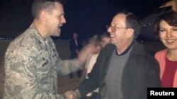 22일 미국 오하이오주 라이트-패터슨 공군기지에 도착한 제프리 파울(가운데) 씨가 존 데빌리 대령(왼쪽)의 환영을 받고 있다. 오른쪽은 부인 타티아나 파울 씨.