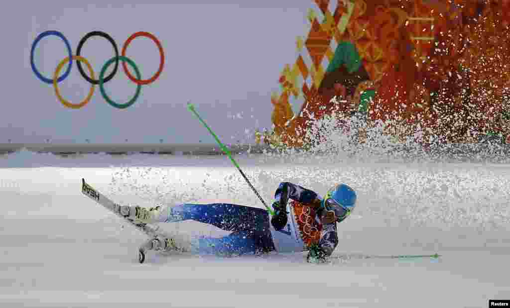 Winner Ted Ligety of the U.S. falls to the ground after the second run of the men&#39;s alpine skiing giant slalom event, Rosa Khutor Alpine Center, Feb. 19, 2014. 