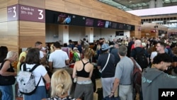 صف طولانی مسافران در فرودگاه براندنبرگ، آلمان، در پی اختلال گسترده جهانی در سیستم‌های مایکروسافت. جمعه ٢٩ تیر ۱۴۰۳