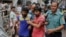 Suspected members of the banned Islamic militant outfit Ansarullah Bangla Team, Sadek Ali (second right) and Aminul Mollick (front left) are escorted by policemen along with another suspect from a court in Dhaka, Bangladesh, Aug. 19, 2015.