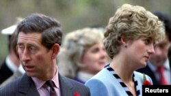 FILE - Princess Diana and Prince Charles look in different directions, Nov. 3, during a service held to commemorate the 59 British soldiers killed in action during the Korean War, Nov. 3, 1992. 