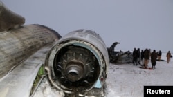 FILE - The wreckage of an airplane is seen after a crash in Deh Yak district of Ghazni province, Afghanistan, Jan. 27, 2020. 
