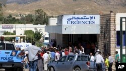 Des habitants se rassemblent devant l'hôpital de Kasserine, près de la frontière algérienne, jeudi 17 juillet 2014, après deux attaques simultanées contre des postes par des militants, faisant au moins 14 morts. (Photo AP / Mouldi Kraeim)