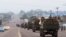 FILE - Congo military trucks carrying Congolese troops drive in a main street after violence erupted due to the delay of the presidential elections in Kinshasa, Democratic Republic of Congo, Sept. 20, 2016.