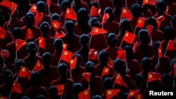 Performers hold flags of the Communist Party of China during an event to celebrate the 90th anniversary of the founding of the party, at the Mercedes-Benz Arena in Shanghai, on June 30, 2011. (Reuters/Carlos Barria)