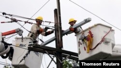 FILE - Crews work to restore power after Hurricane Barry in New Orleans, Louisiana, July 14, 2019.