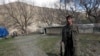 FILE - A Kurdistan Workers' Party (PKK) fighter stands guard at the Qandil mountains near the Iraq-Turkish border in Sulaimaniya, 330 km (205 miles) northeast of Baghdad, March 24, 2013.