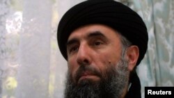FILE - Gulbuddin Hekmatyar speaks to a reporter in 2002.