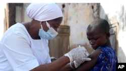 FILE - A health worker administers a cervical cancer vaccine HPV Gardasil to a girl on the street in Ibadan, Nigeria, on May 27, 2024. More than half of Africa's 54 nations – 28 – have introduced the vaccine in their immunization programs. 