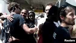 Migrants disembark from the Aquarius rescue ship after arriving to port in Valencia, Spain, June 17, 2018. (Kenny Karpov/SOS Mediterranee/Handout via Reuters)