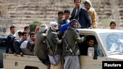 FILE - Houthi fighters ride a patrol truck in Sana'a, Yemen, March 5, 2015. Thousands of the rebels are conducting military exercises near Saudi Arabia, sources say.