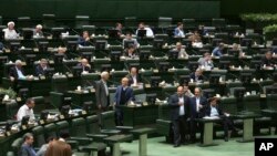 Iranian lawmakers attend a session of parliament in Tehran, April 16, 2019. Iran's lawmakers overwhelmingly approved a bill labeling U.S. forces in the Middle East as terrorist, a day after the U.S. terrorism designation for Iran's Revolutionary Guard formally took effect.