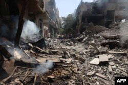 Menghancurkan bangunan menyusul operasi Pasukan Khusus Israel di kamp Nuseirat, di Jalur Gaza tengah pada 8 Juni 2024, di tengah konflik yang sedang berlangsung antara Israel dan kelompok militan Hamas Palestina. (Foto: AFP)