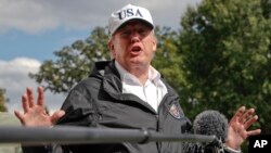 President Donald Trump answers a question from the media as he arrives at the White House, Sept. 14, 2017, in Washington. 